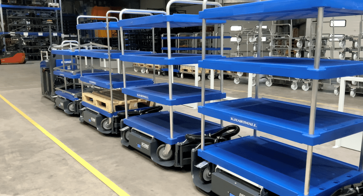 LiftLiner Tugger train with mother-daughter carts in blue.
